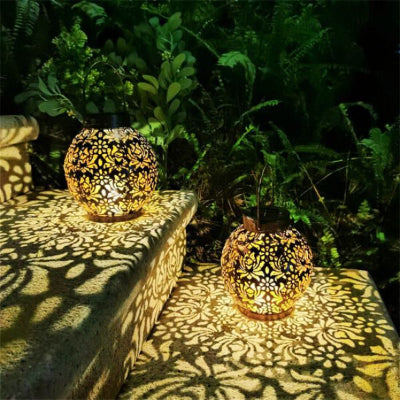 lanterne extérieur solaire bronze projetant motifs lumineux sur marches
